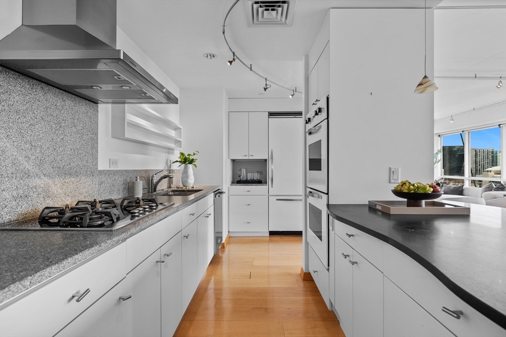 25 Channel Center Street, Unit 1102 Boston, MA 02210 - Photo 11 of 28 a kitchen with stainless steel appliances a sink stove and refrigerator