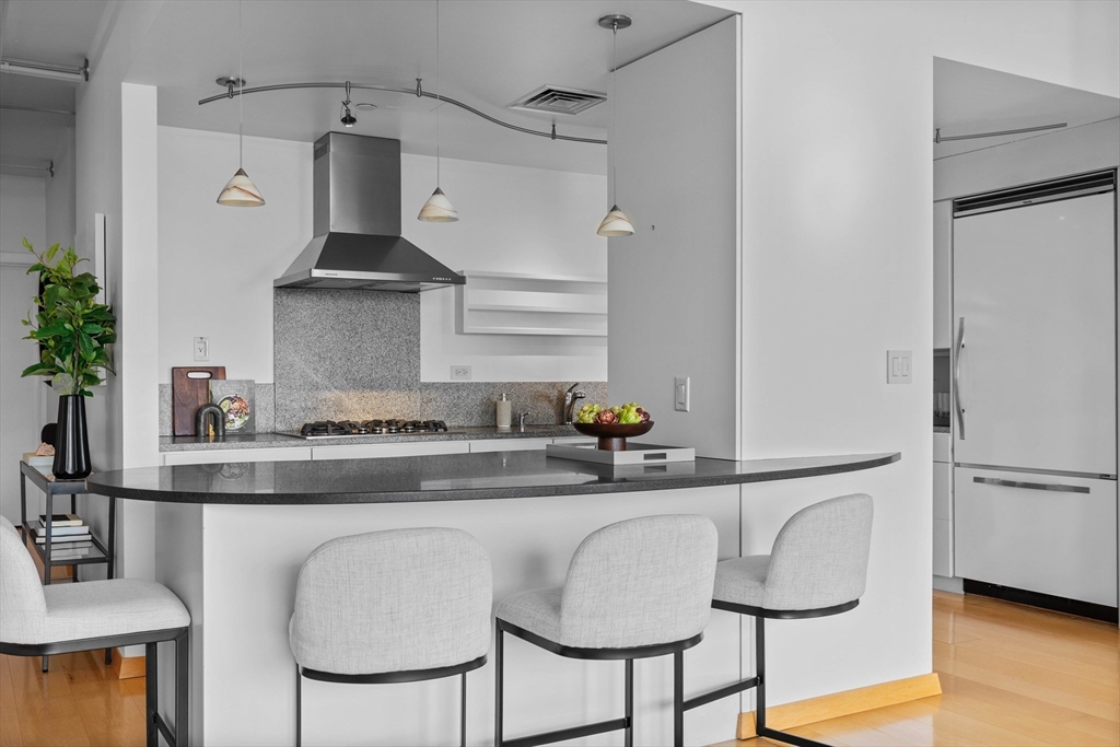 25 Channel Center Street, Unit 1102 Boston, MA 02210 - Photo 12 of 28 a kitchen with stainless steel appliances a sink and cabinets