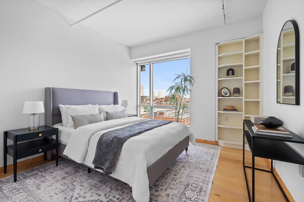 25 Channel Center Street, Unit 1102 Boston, MA 02210 - Photo 18 of 28 a bedroom with a bed and a potted plant