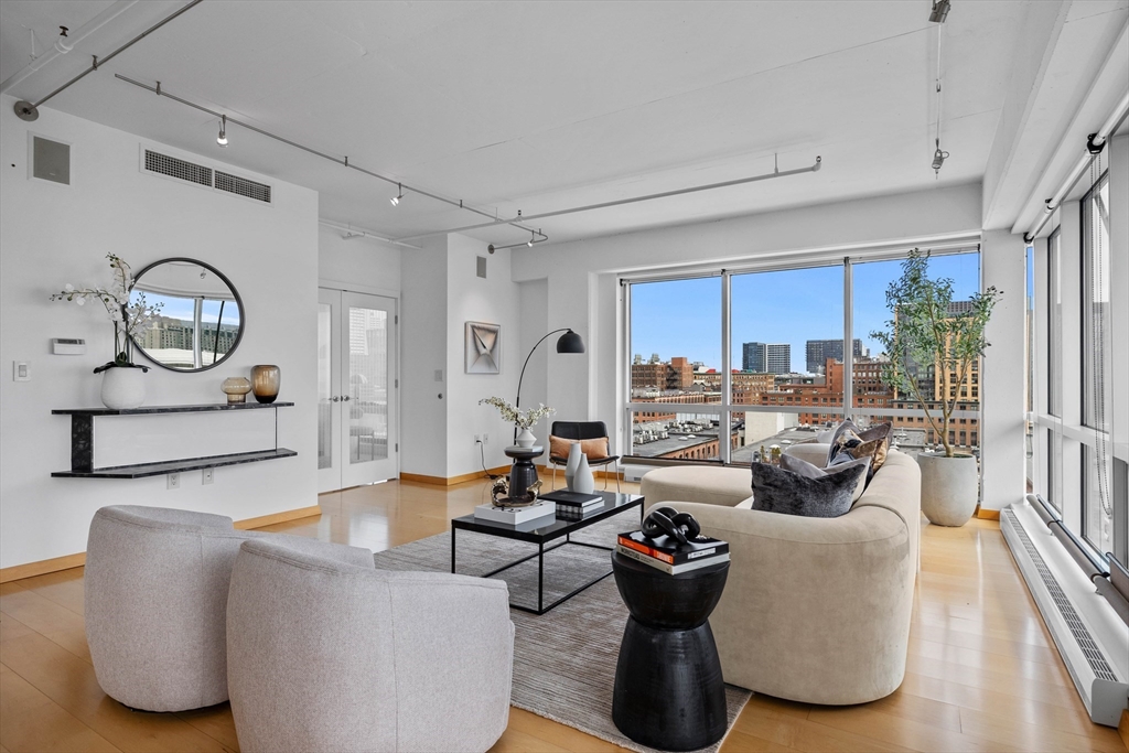 25 Channel Center Street, Unit 1102 Boston, MA 02210 - Photo 4 of 28 a living room with furniture and a large window