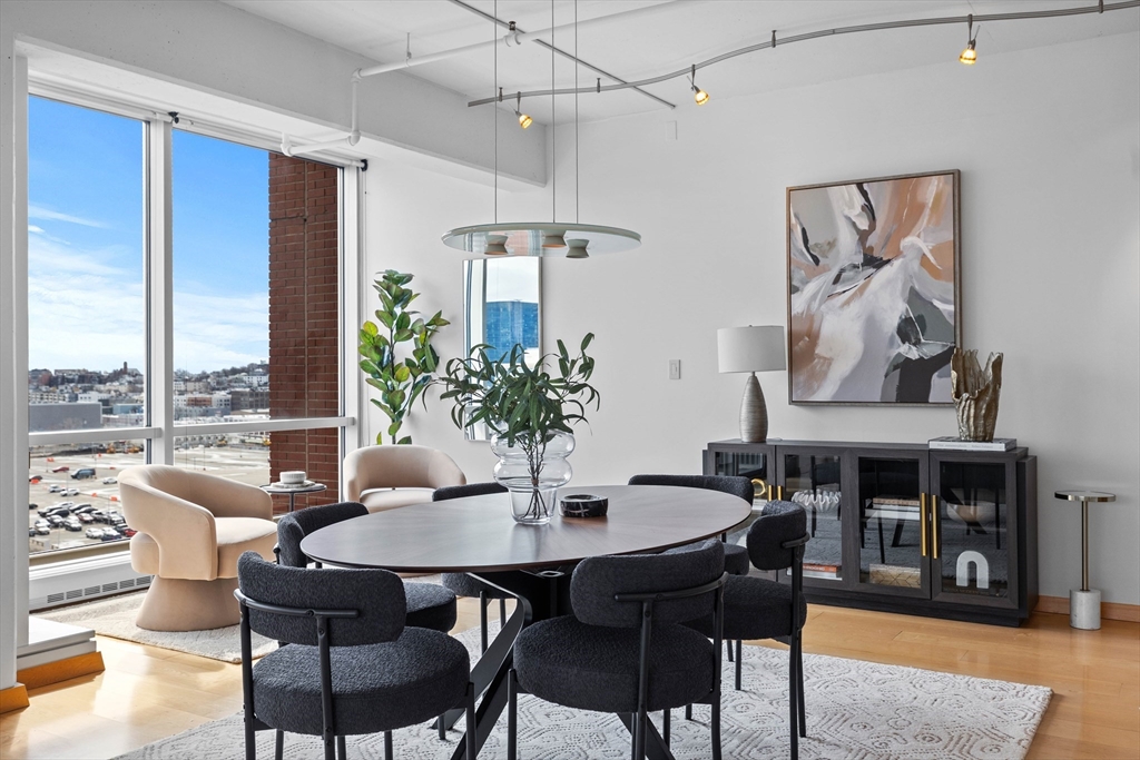 25 Channel Center Street, Unit 1102 Boston, MA 02210 - Photo 5 of 28 a view of a dining room with furniture window and wooden floor