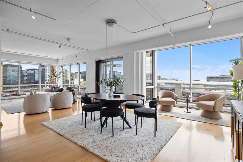 25 Channel Center Street, Unit 1102 Boston, MA 02210 - Photo 6 of 28 a living room with furniture and a large window