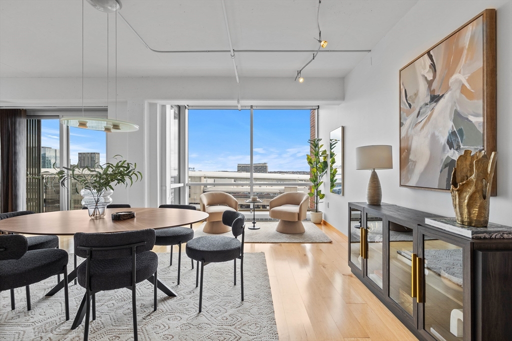 25 Channel Center Street, Unit 1102 Boston, MA 02210 - Photo 9 of 28 a view of a dining room with furniture window and wooden floor