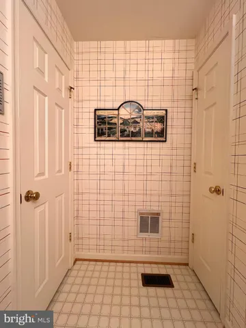 a view of a patio with table and chairs and wooden floor