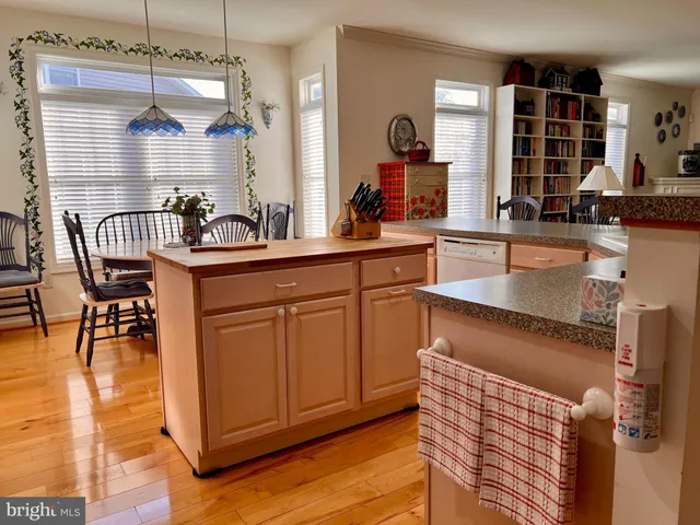 a kitchen with granite countertop a stove a sink and a dining table