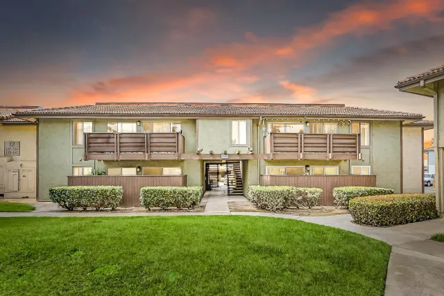 a front view of house with yard and outdoor seating