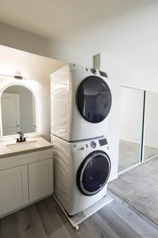 a utility room with sink dryer and washer