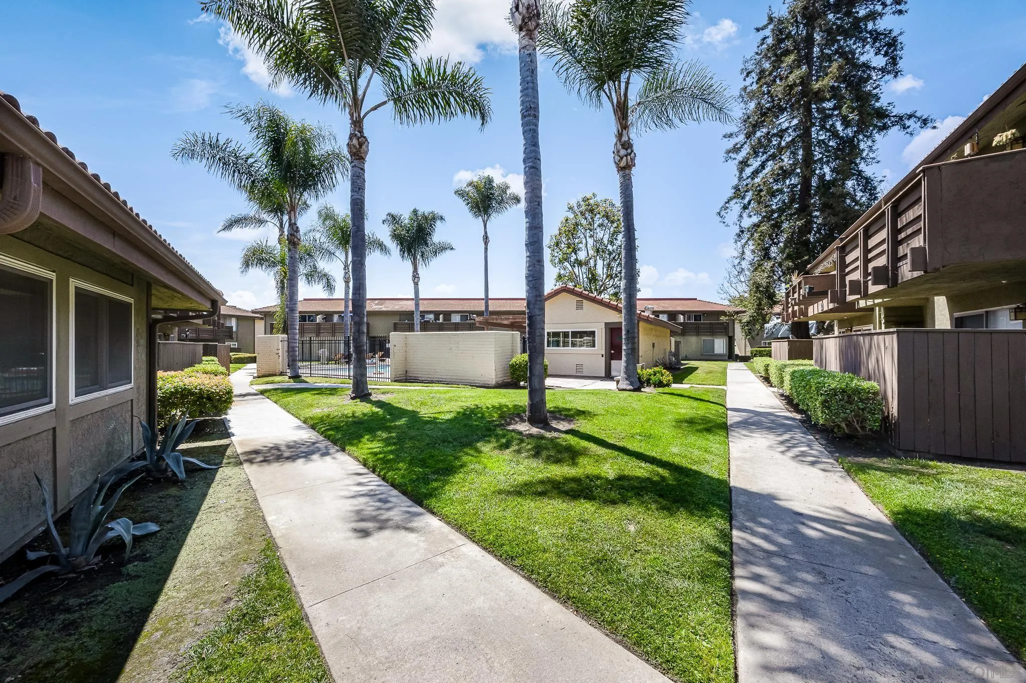 615 Fredricks Avenue, Unit 134 Oceanside, CA 92058 - Photo 30 of 40 a view of a house with a yard and palm trees