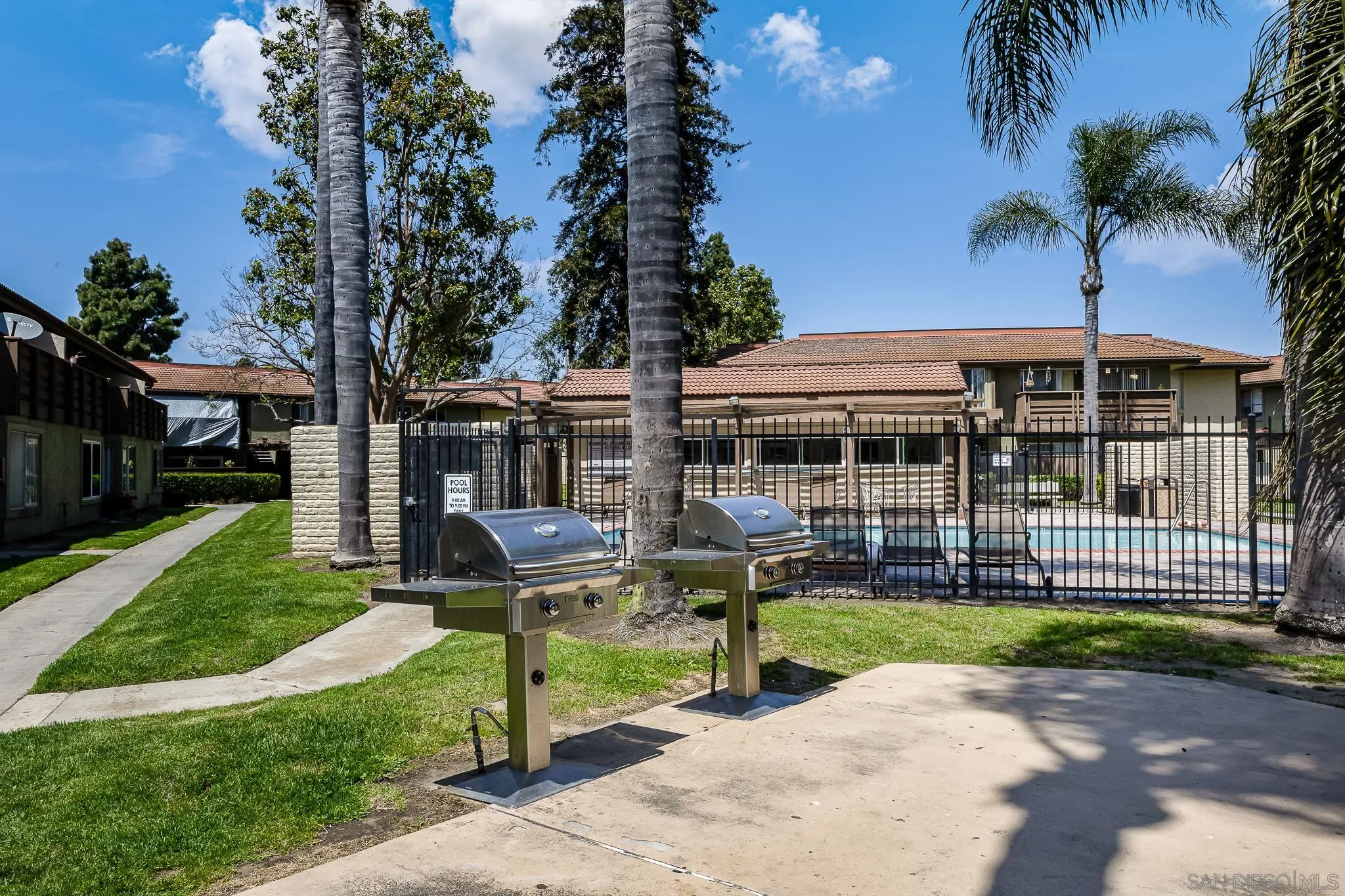 615 Fredricks Avenue, Unit 134 Oceanside, CA 92058 - Photo 32 of 40 a front view of a house with a yard table and chairs