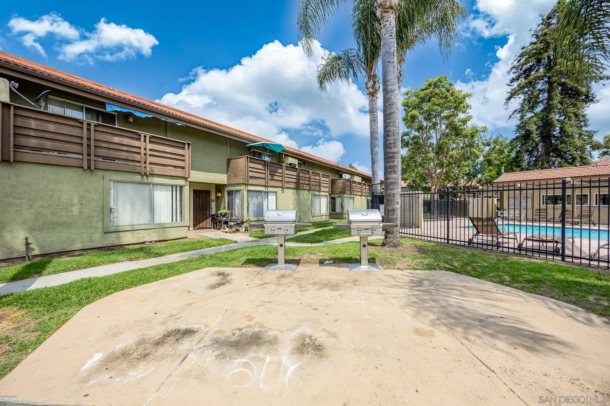 615 Fredricks Avenue, Unit 134 Oceanside, CA 92058 - Photo 34 of 40 a view of a house with a small yard and wooden fence
