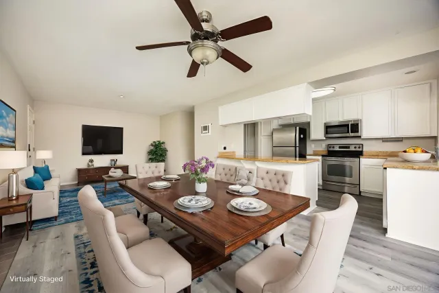 a view of a dining room with furniture and a kitchen