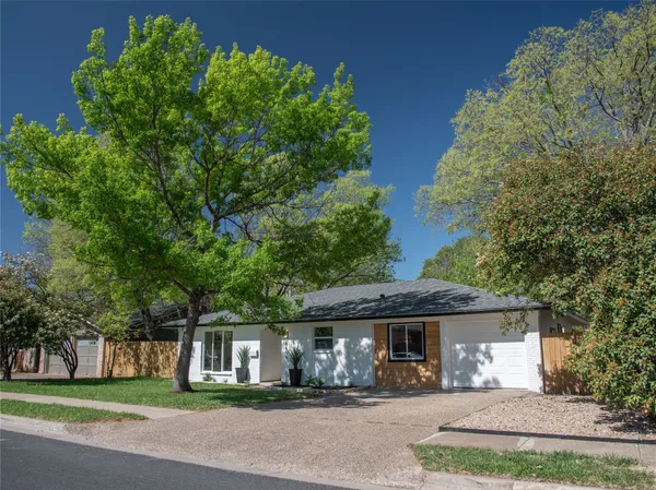 front view of a house with a garden