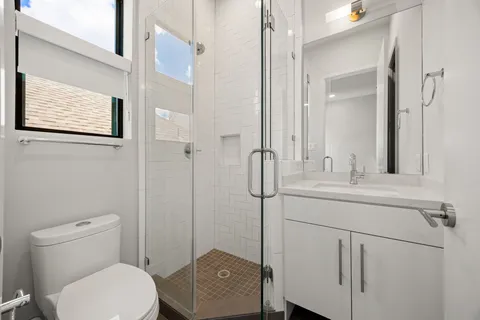 a bathroom with a toilet a sink and mirror