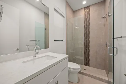 a bathroom with a sink toilet and shower