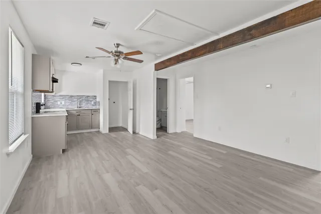 a view of a kitchen with a sink and a stove top oven