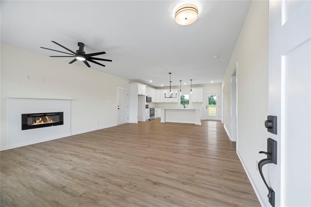 711 Racetrack Road Toccoa, GA 30577 - Photo 2 of 8 a view of kitchen and empty room with wooden floor