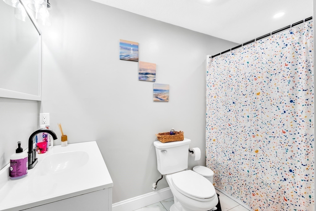 306 Berlin Road Marlborough, MA 01752 - Photo 11 of 36 a white toilet sitting next to a bathroom sink