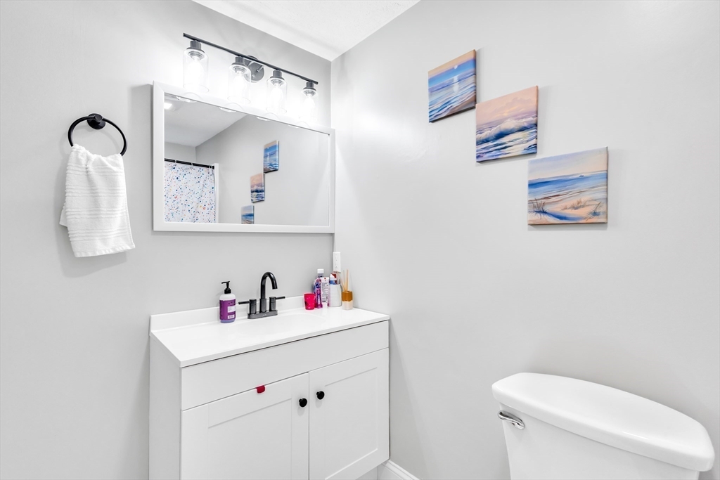 306 Berlin Road Marlborough, MA 01752 - Photo 12 of 36 a bathroom with a sink vanity mirror and toilet