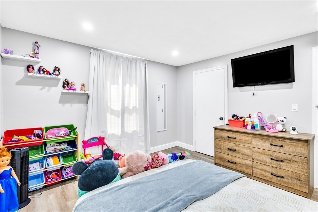 306 Berlin Road Marlborough, MA 01752 - Photo 15 of 36 a bedroom with a bed and a flat screen tv