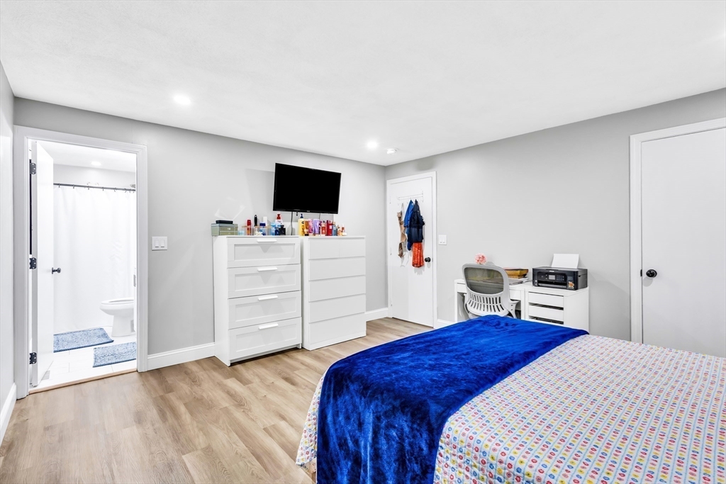 306 Berlin Road Marlborough, MA 01752 - Photo 18 of 36 a bedroom with a bed and a flat screen tv