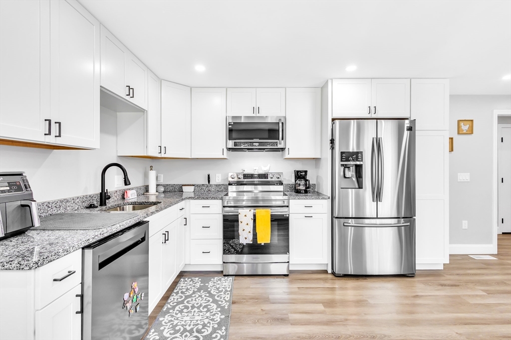 306 Berlin Road Marlborough, MA 01752 - Photo 2 of 36 a kitchen with a refrigerator and a sink