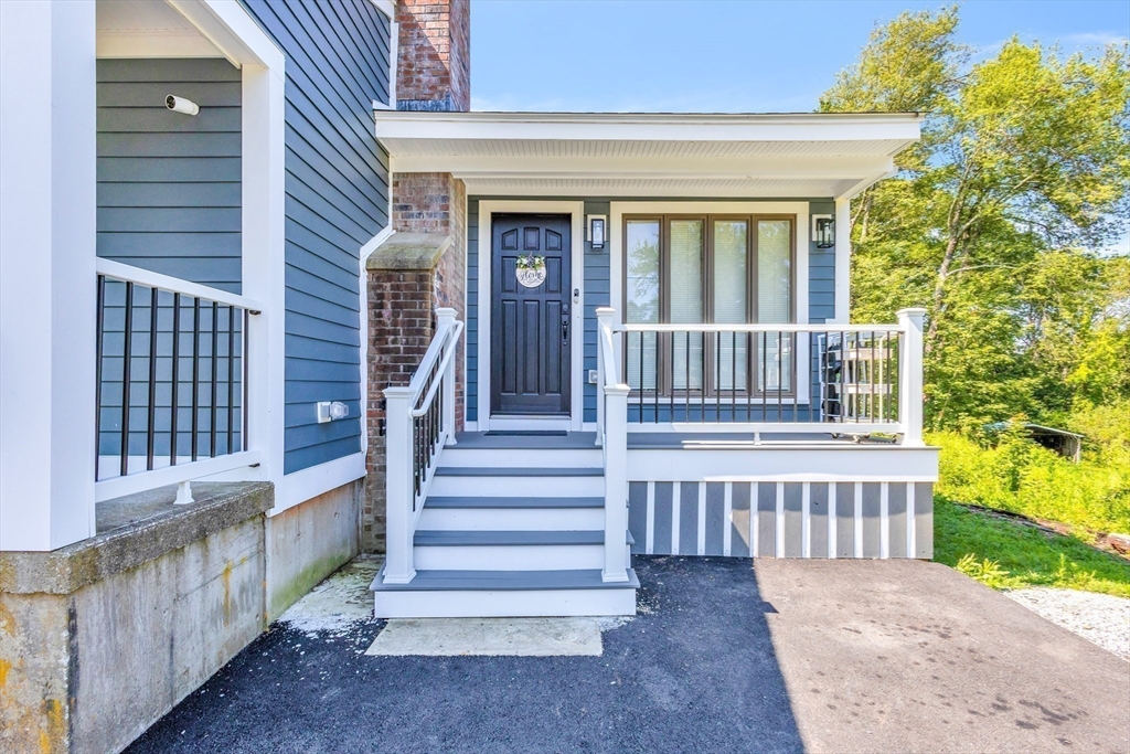 306 Berlin Road Marlborough, MA 01752 - Photo 23 of 36 a view of a house with wooden fence and a porch