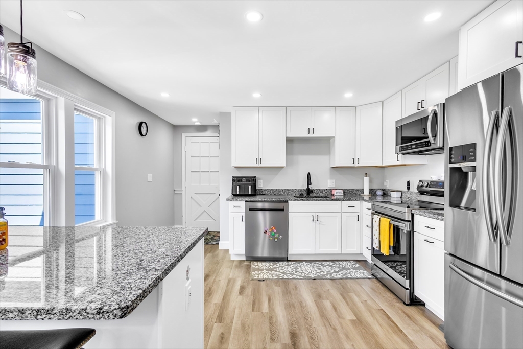 306 Berlin Road Marlborough, MA 01752 - Photo 3 of 36 a kitchen with stainless steel appliances granite countertop a sink stove and refrigerator