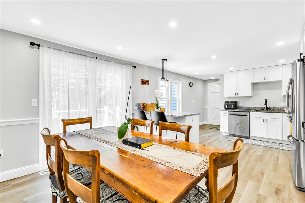 306 Berlin Road Marlborough, MA 01752 - Photo 4 of 36 a kitchen with stainless steel appliances granite countertop a table chairs and a refrigerator