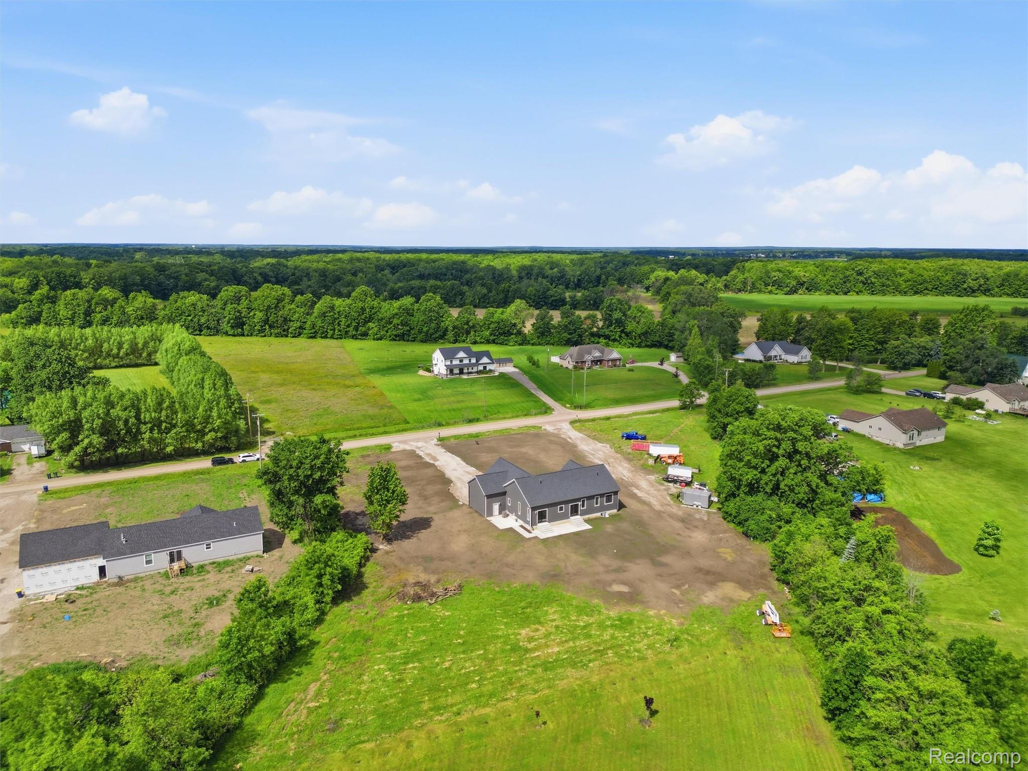 77850 Angling Road Richmond, MI 48062 - Photo 52 of 54 Expansive aerial view showcasing a newly constructed single-story residence with a dark gray exterior and white trim