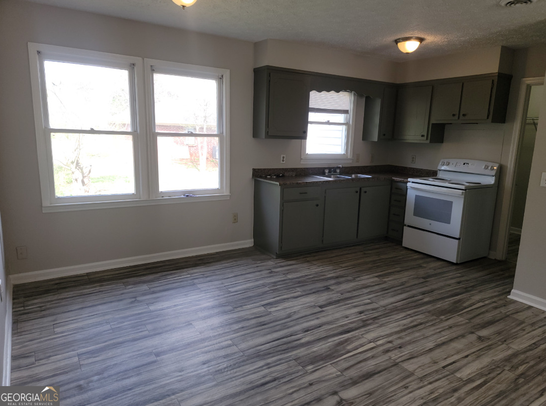 15 Greenview Drive McDonough, GA 30253 - Photo 13 of 26 a kitchen with granite countertop a stove and a sink