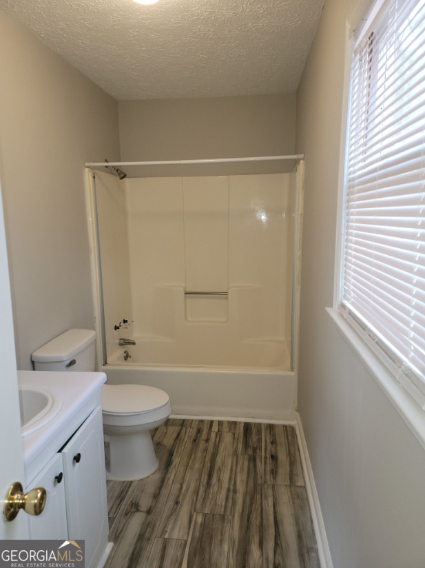 15 Greenview Drive McDonough, GA 30253 - Photo 18 of 26 a bathroom with a sink toilet and shower