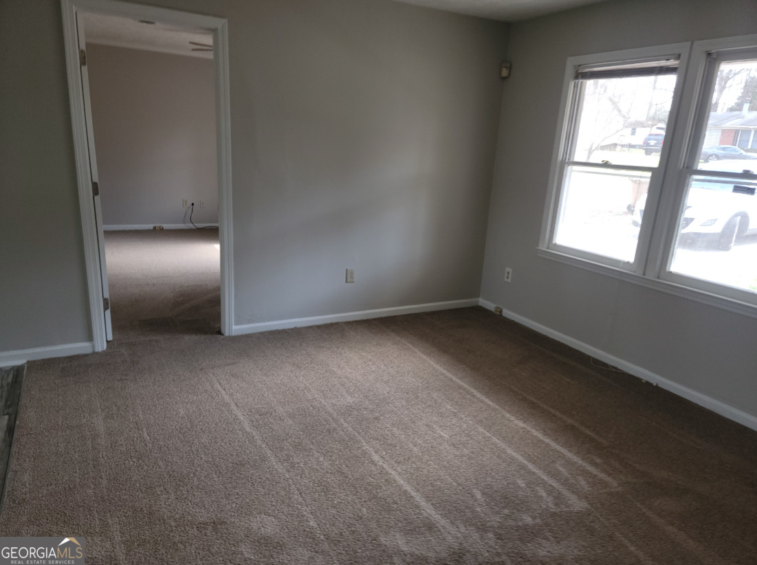 15 Greenview Drive McDonough, GA 30253 - Photo 7 of 26 an empty room with a empty space and windows