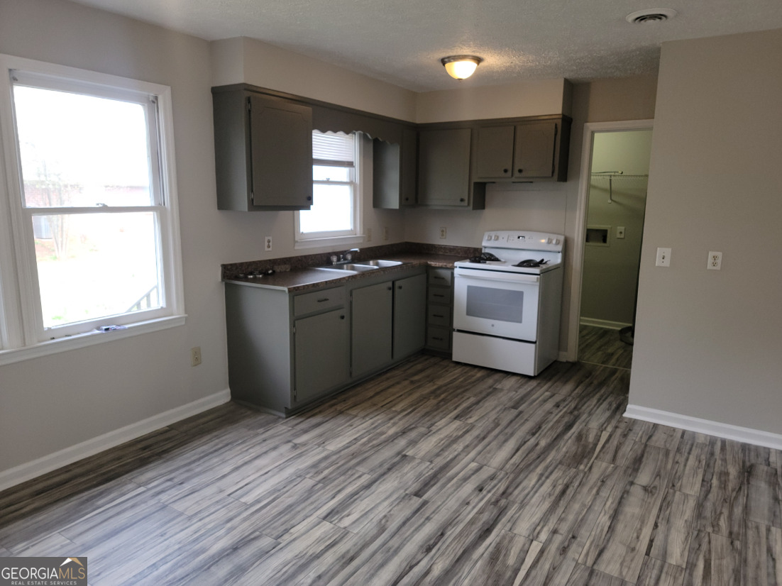 15 Greenview Drive McDonough, GA 30253 - Photo 10 of 26 a kitchen with wooden floors and a stove