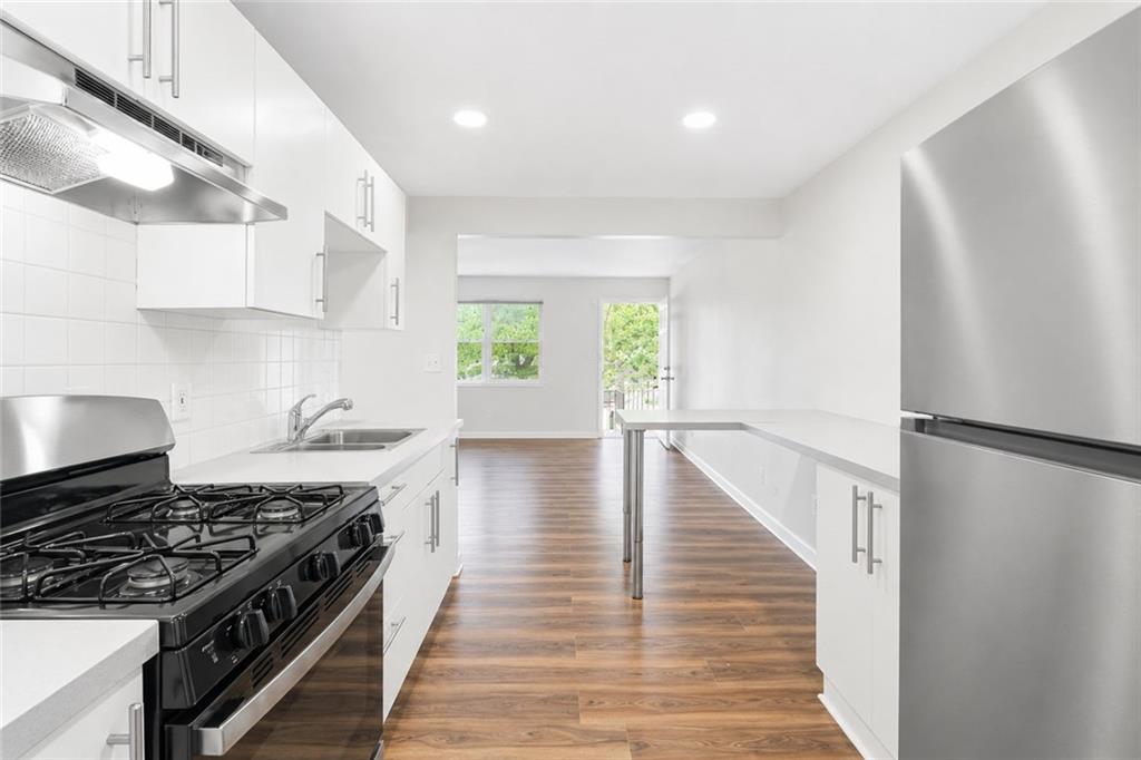 3193 East Point Street, Unit 4 Atlanta, GA 30344 - Photo 9 of 20 a kitchen with a stove a refrigerator and a window