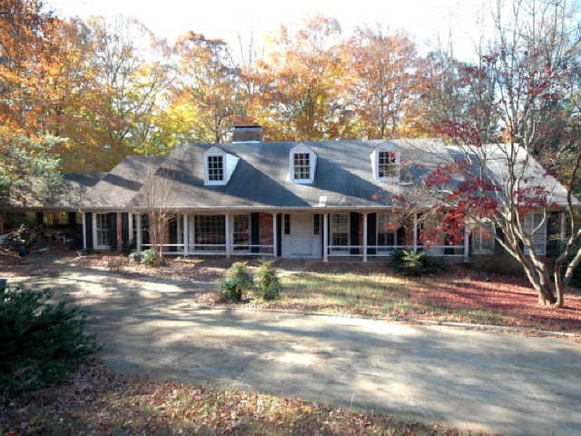 3604 Paces Valley Road Northwest, Unit 10 Atlanta, GA 30327 - Photo 1 of 1 a front view of a house with a yard
