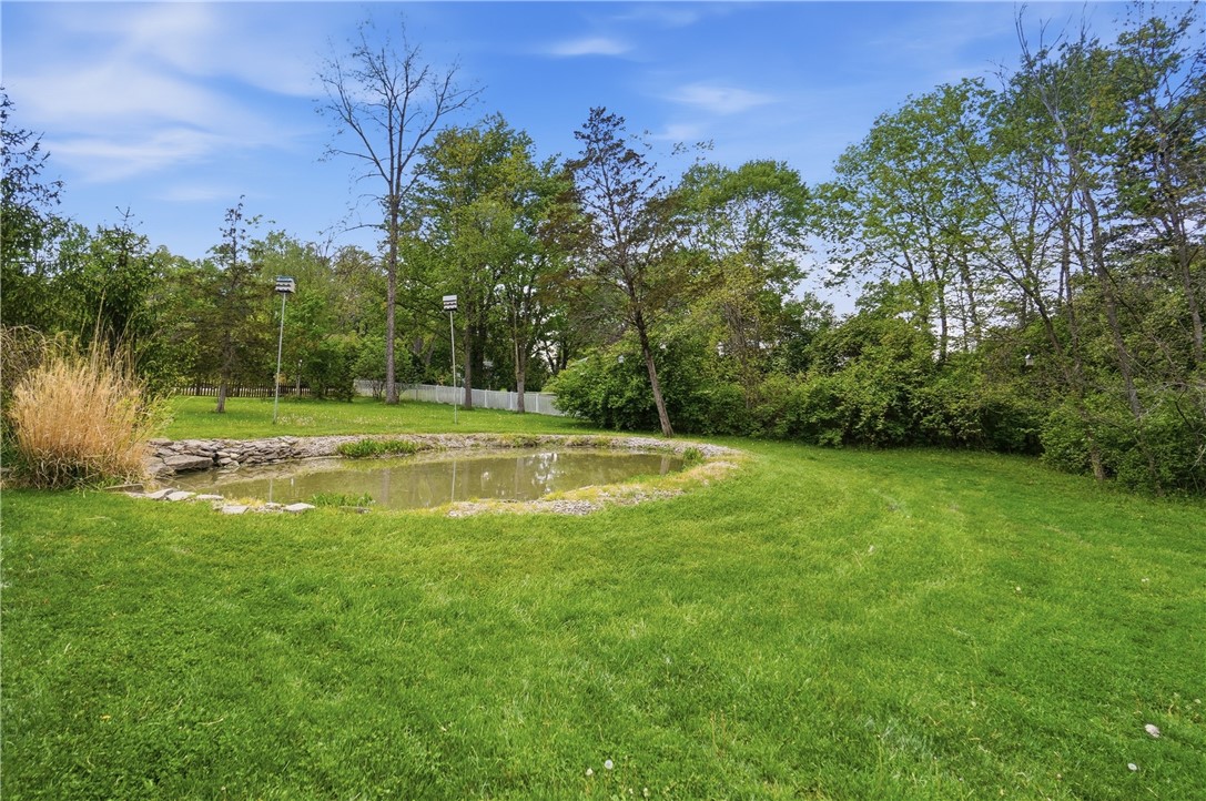 1208 Jarva Lane Springboro, OH 45066 - Photo 72 of 75 This serene landscape features a tranquil pond amidst lush greenery, perfect for a peaceful retreat.