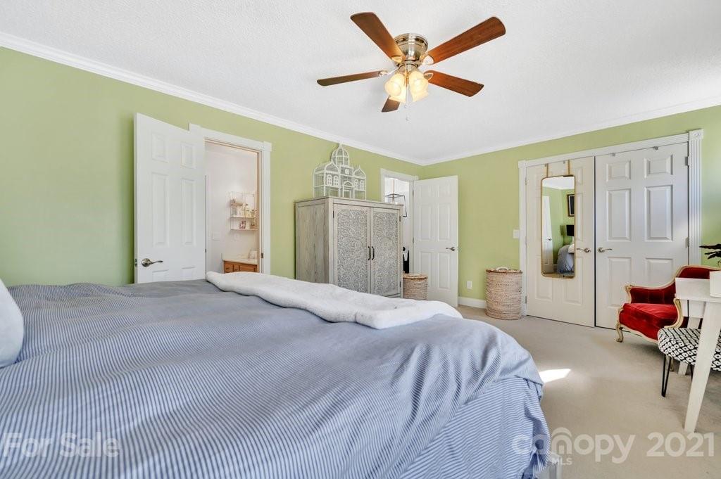 3080 Point Clear Drive Tega Cay, SC 29708 - Photo 11 of 23 a bedroom with a bed and a chandelier