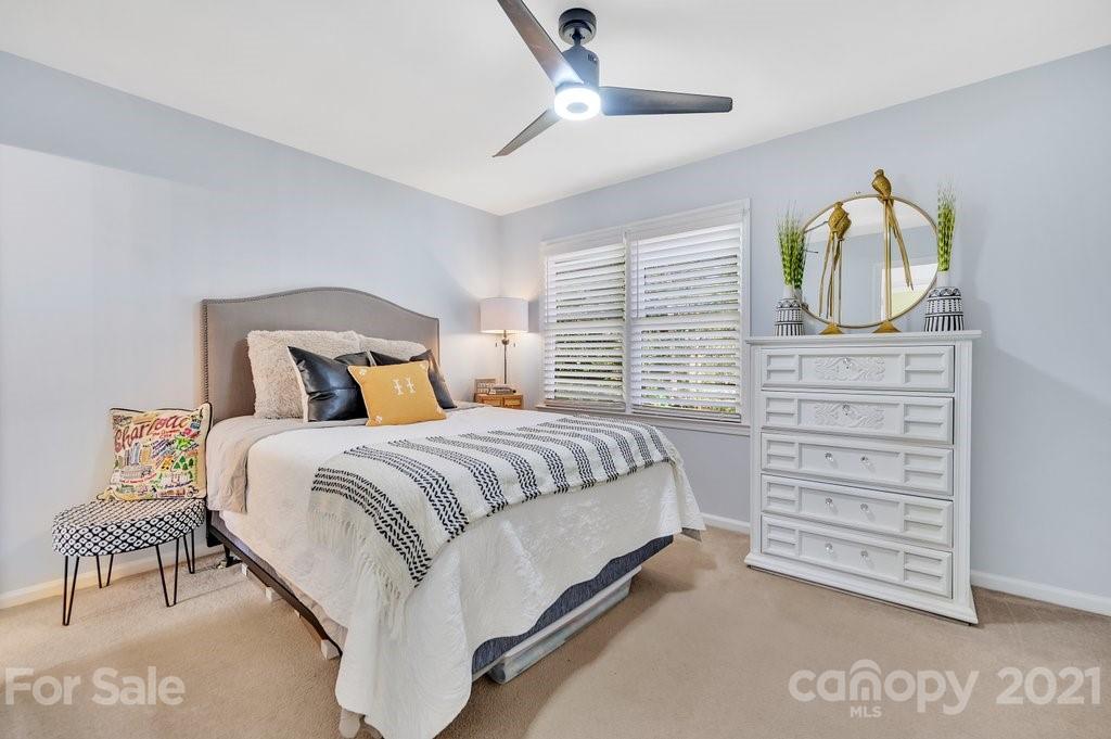 3080 Point Clear Drive Tega Cay, SC 29708 - Photo 13 of 23 a bedroom with a bed and a chandelier