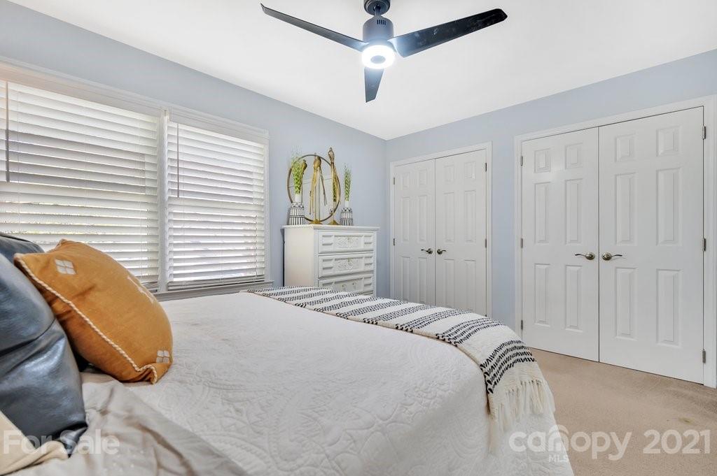 3080 Point Clear Drive Tega Cay, SC 29708 - Photo 14 of 23 a bedroom with a bed and a chandelier