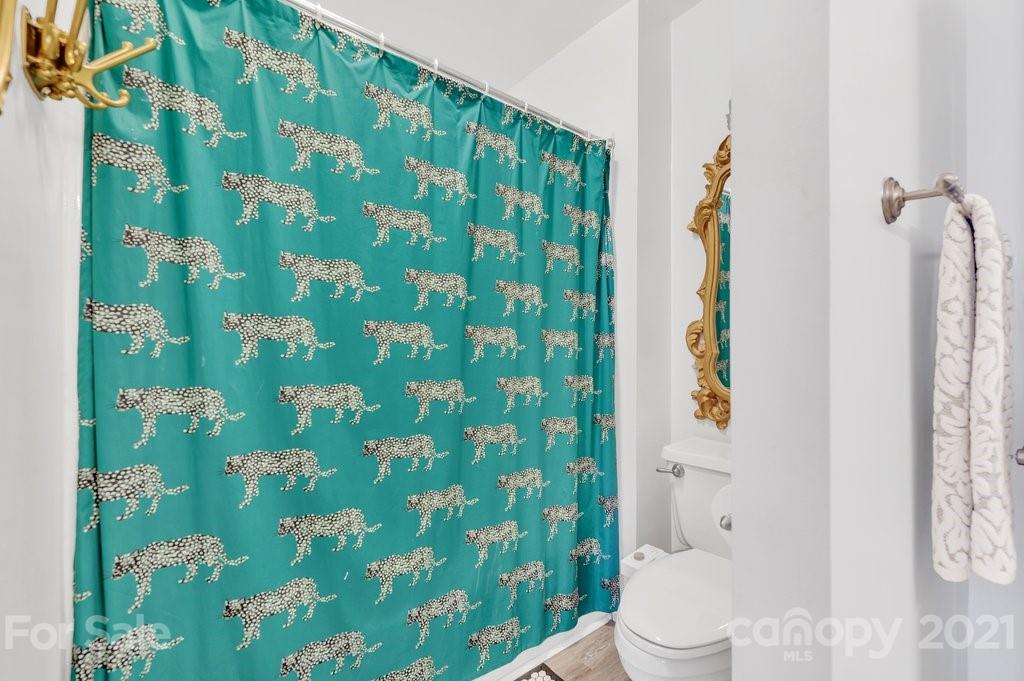 3080 Point Clear Drive Tega Cay, SC 29708 - Photo 16 of 23 a white toilet sitting next to a shower curtain