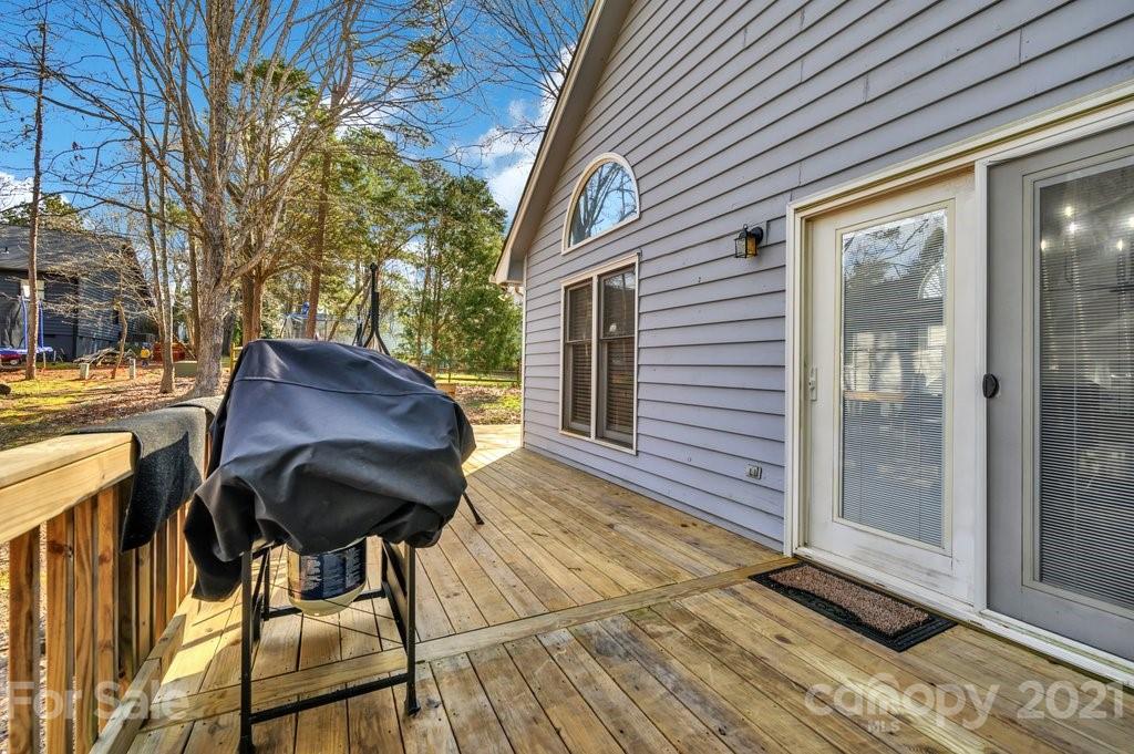 3080 Point Clear Drive Tega Cay, SC 29708 - Photo 20 of 23 a view of a patio with table and chairs and wooden floor