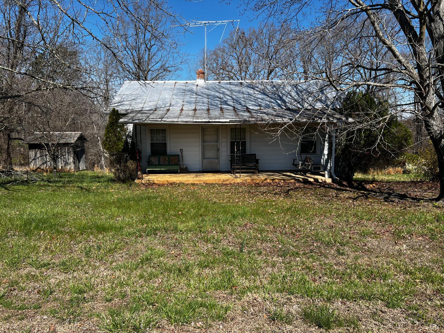 a view of a house with a yard and tree