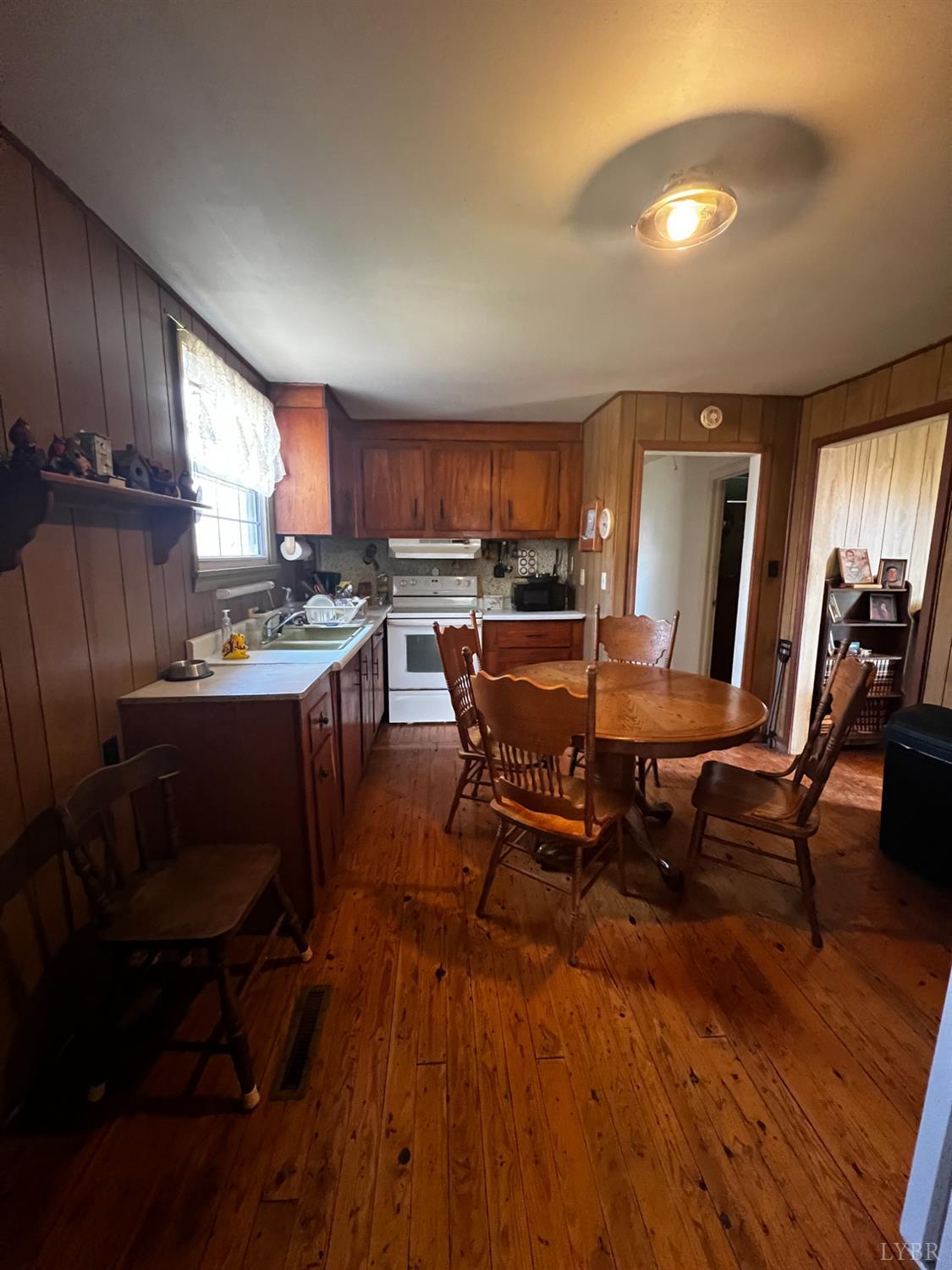 955 Peerman School Road Altavista, VA 24517 - Photo 4 of 7 a kitchen with a table chairs refrigerator and cabinets