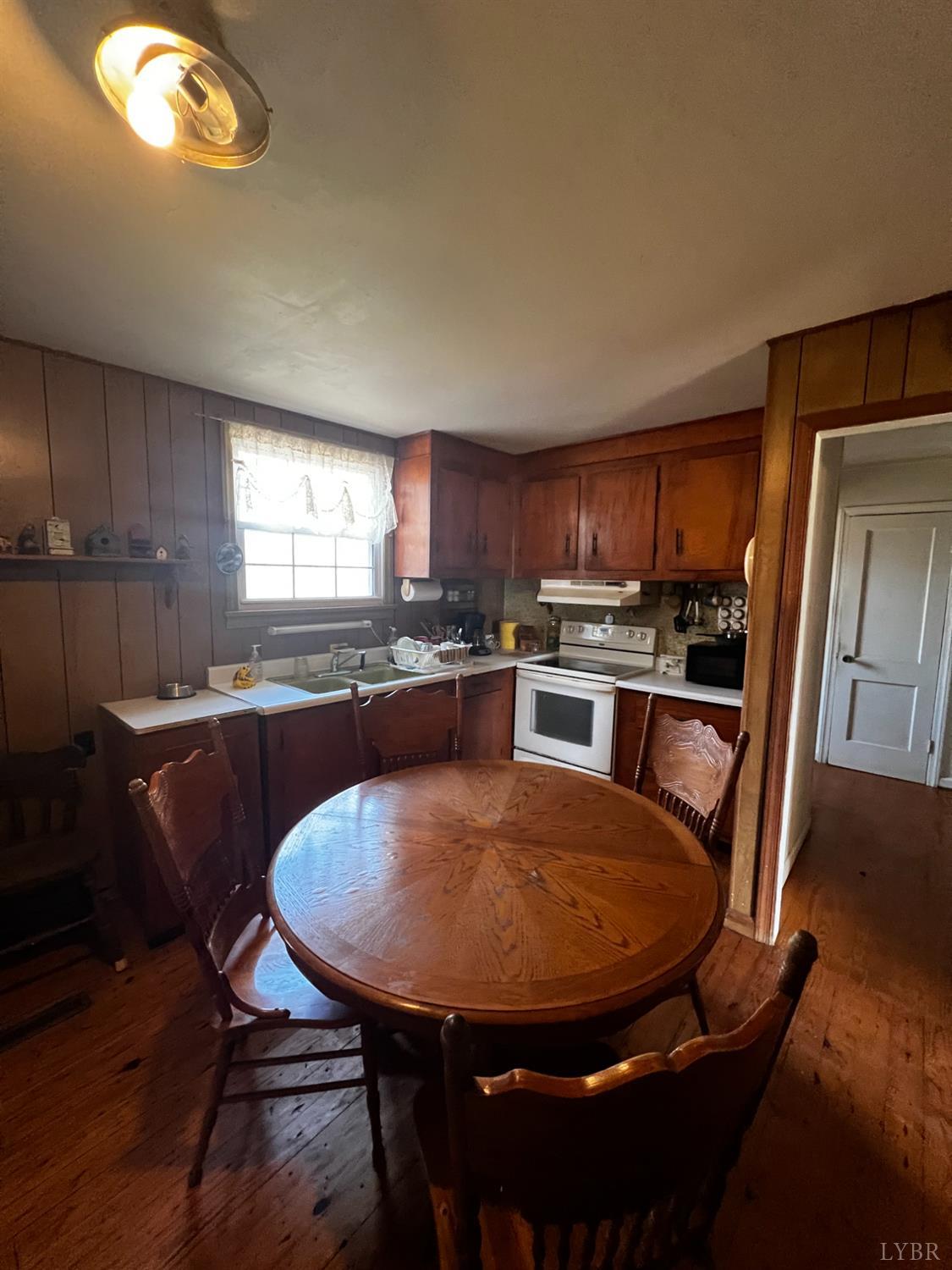 955 Peerman School Road Altavista, VA 24517 - Photo 5 of 7 a kitchen with stainless steel appliances granite countertop a sink window and dining table