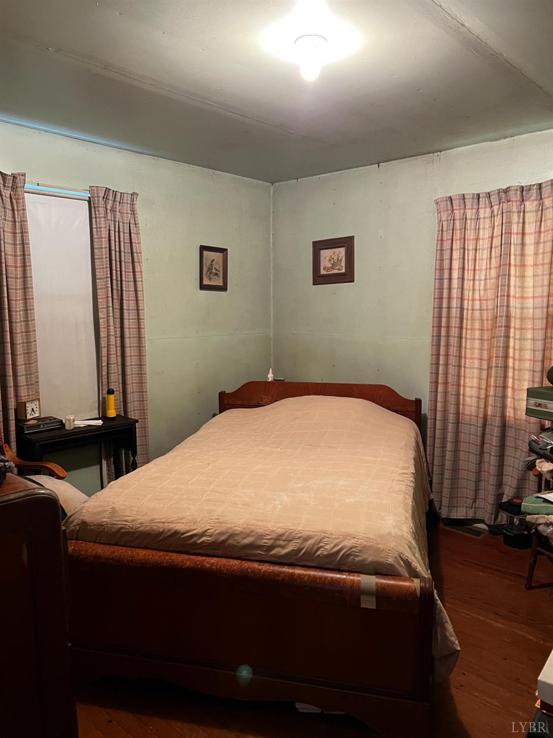 955 Peerman School Road Altavista, VA 24517 - Photo 6 of 7 a bedroom with a bed and a flat tv screen on dresser