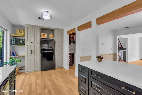 a kitchen with a refrigerator and a sink
