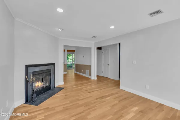 a view of an empty room with a fireplace