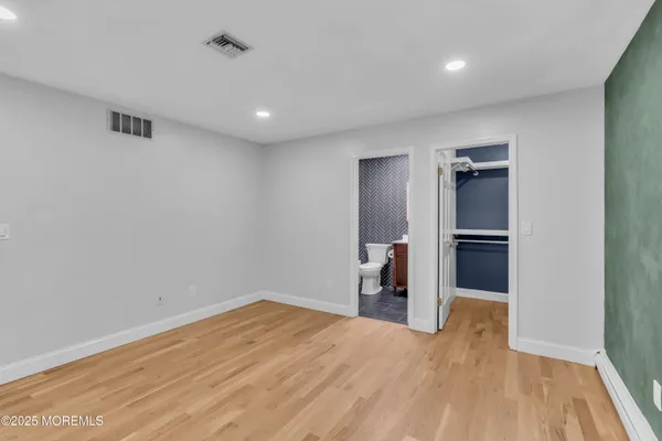 a view of a kitchen with a sink and refrigerator