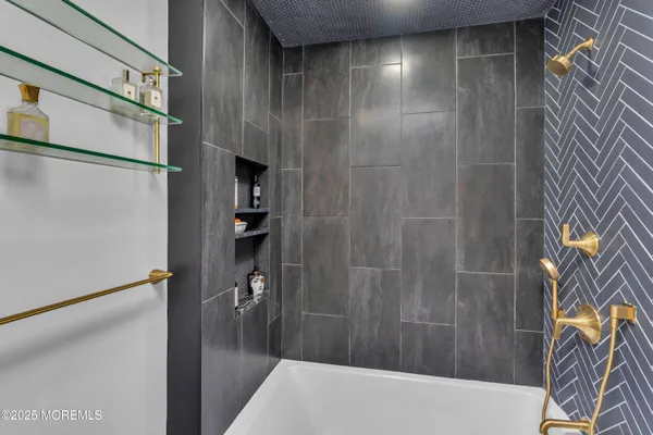 a bathroom with a bathtub and shower