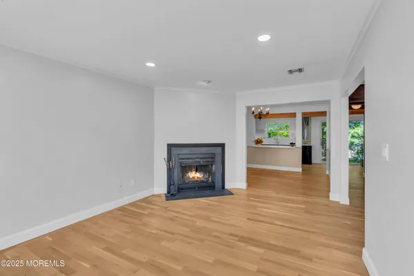 a view of an empty room with a fireplace and a window